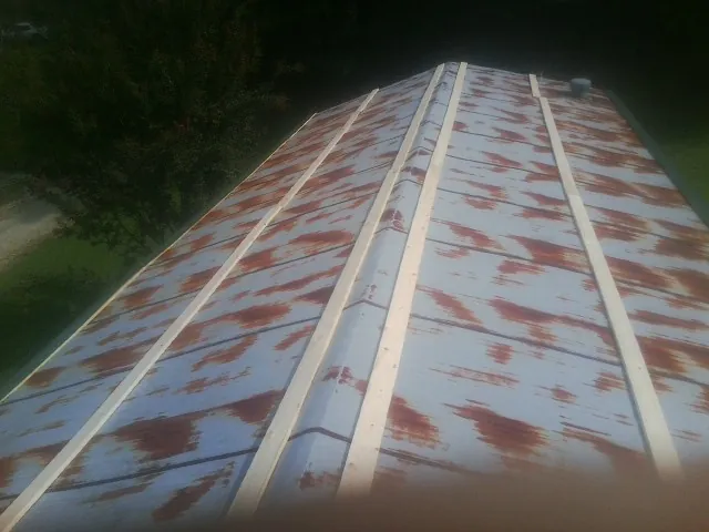 Rusted metal roof panels with new wood purlins before replacement — Storm Damage Roof Repair in Pinole by Roofing Brothers