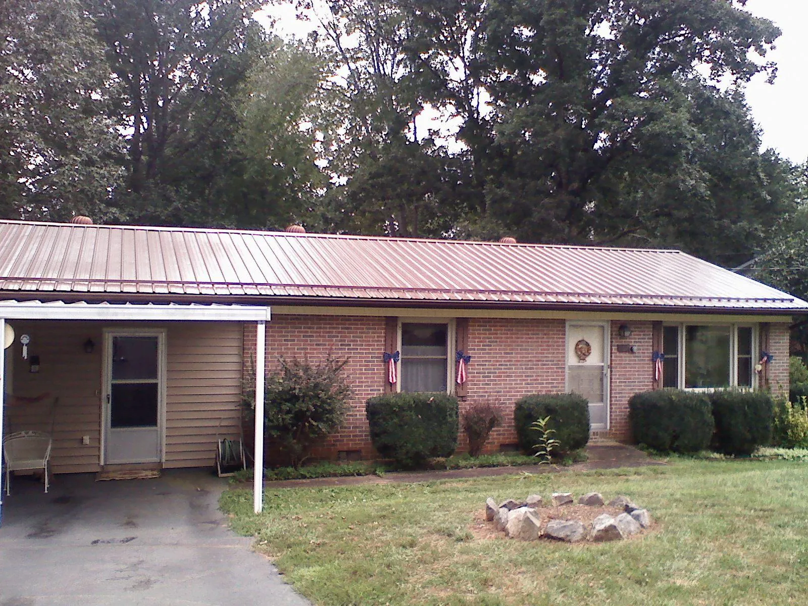 Bronze metal roof and carport on a brick ranch home — Roof Repair work by our crew in Pinole